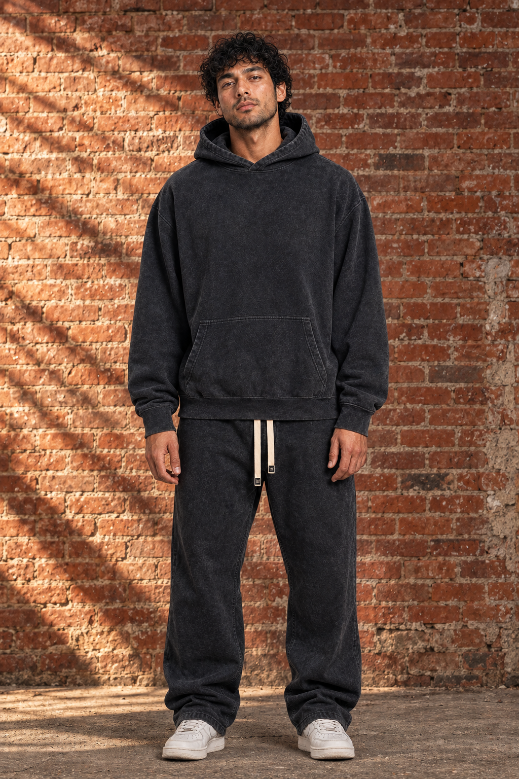 Black Snow Wash Fleece Oversize Hoodie, front view on model against brick wall
